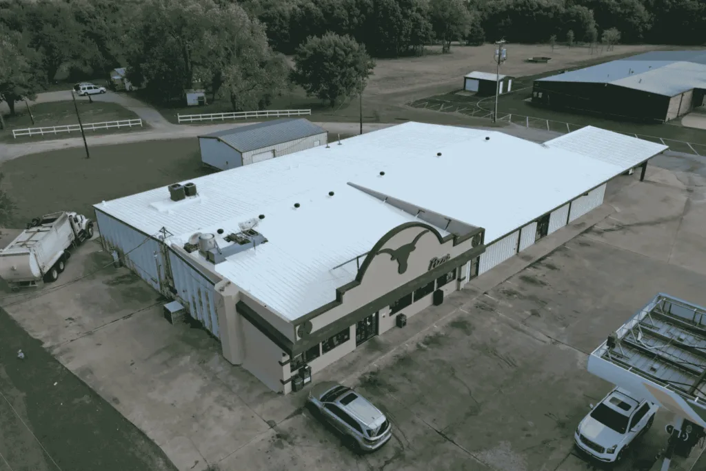 Crew performing flat roof installation for large commercial facility